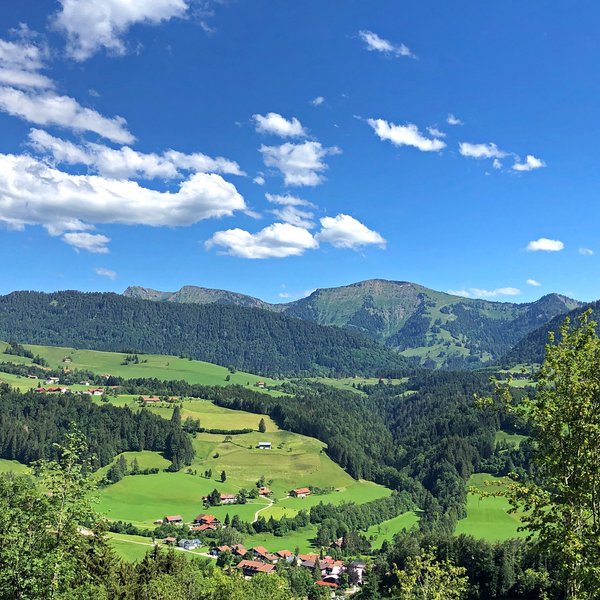 Oberstaufen: Hotel Allgäu Sonne Green hills and mountains under blue sky with scattered clouds