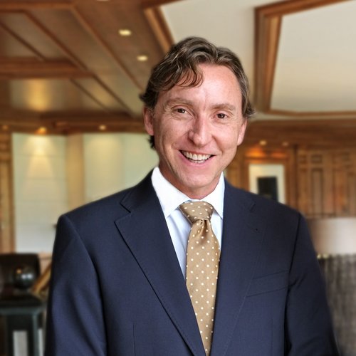 Our mission: your dream holiday in Oberstaufen Smiling man in suit with polka dot tie in a wooden interior