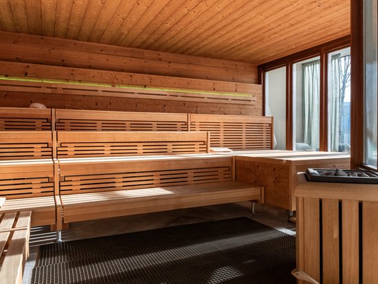 Hotel mit Pool im Allgäu: Allgäu Sonne Helle finnische Sauna mit Holzbänken und großer Fensterfront