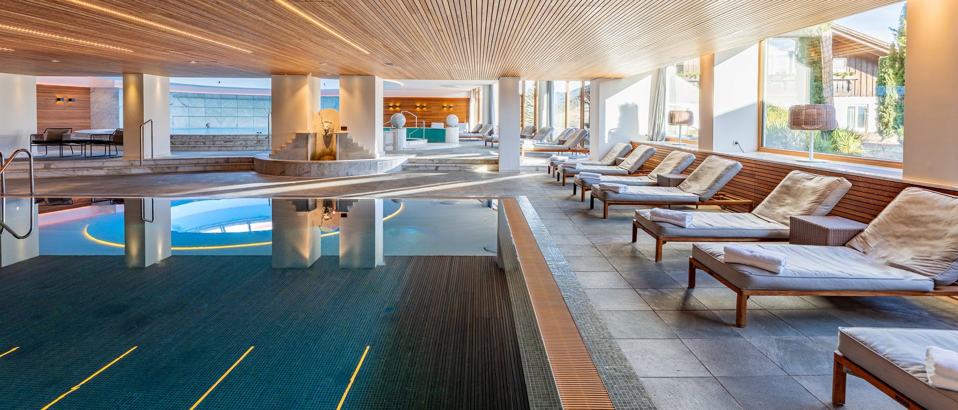 Hotel mit Pool im Allgäu: Allgäu Sonne Innenansicht eines modernen Spa-Bereichs mit Pool und Liegestühlen